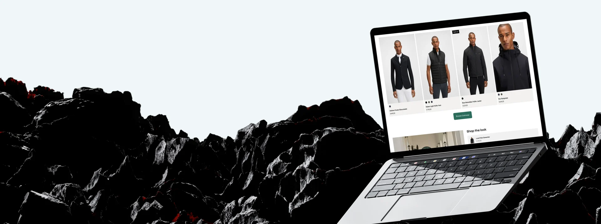 The BOSS Equestrian storefront shown on a laptop above black volcanic rock