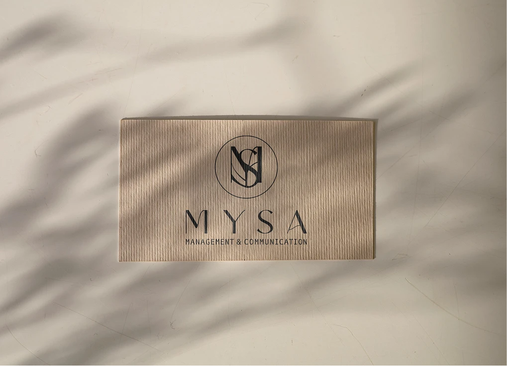 The MYSA monogram and wordmark embossed on soft draped fabric