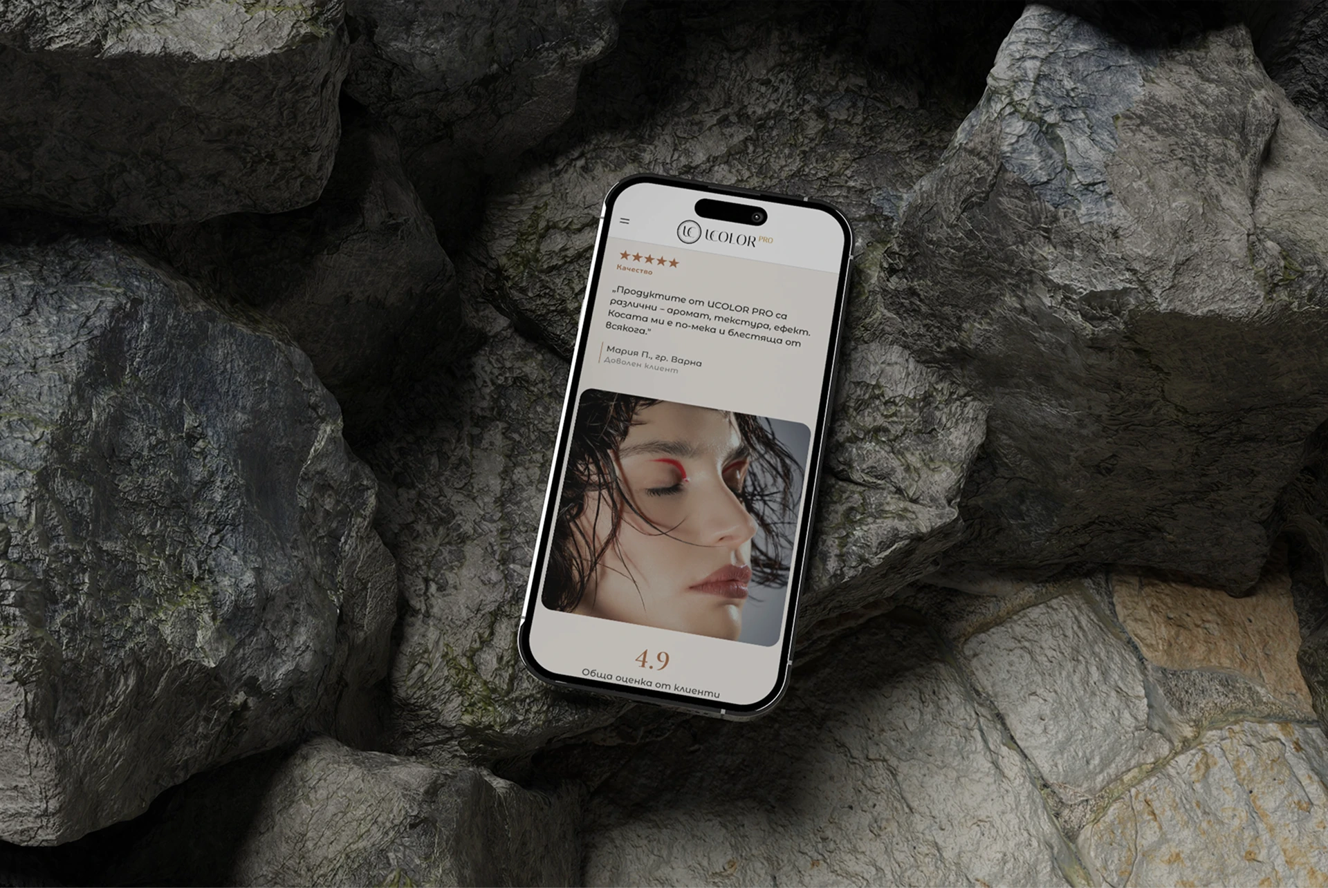 The UCOLOR review page open on a phone resting on stone